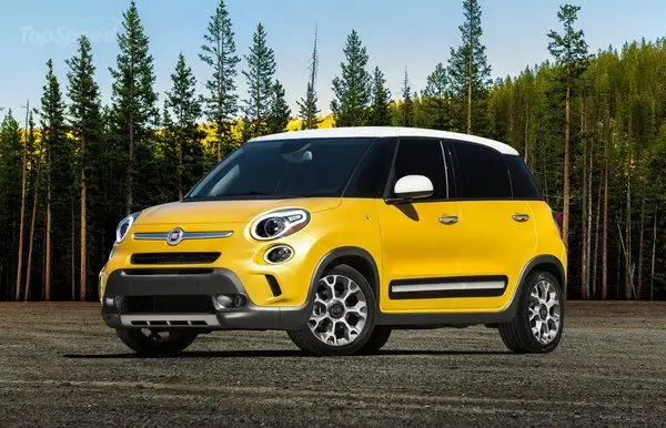 2014 Fiat 500L Trekking - Engine Stories Yellow car parked in front of a forest, showcasing a modern design and vibrant color under a clear sky.