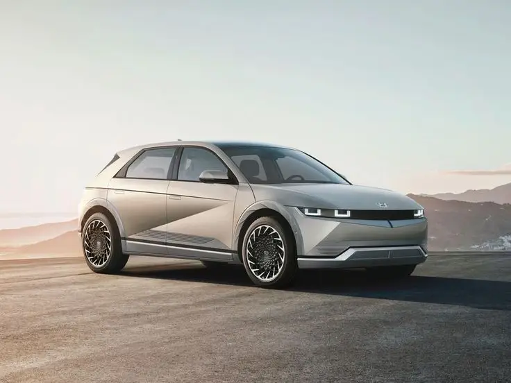 2022 Hyundai Ioniq 5 EV bows with knife-edged look 2-way charging - Engine Stories Sleek silver electric car parked on a scenic road with mountains in the background under a clear sky.
