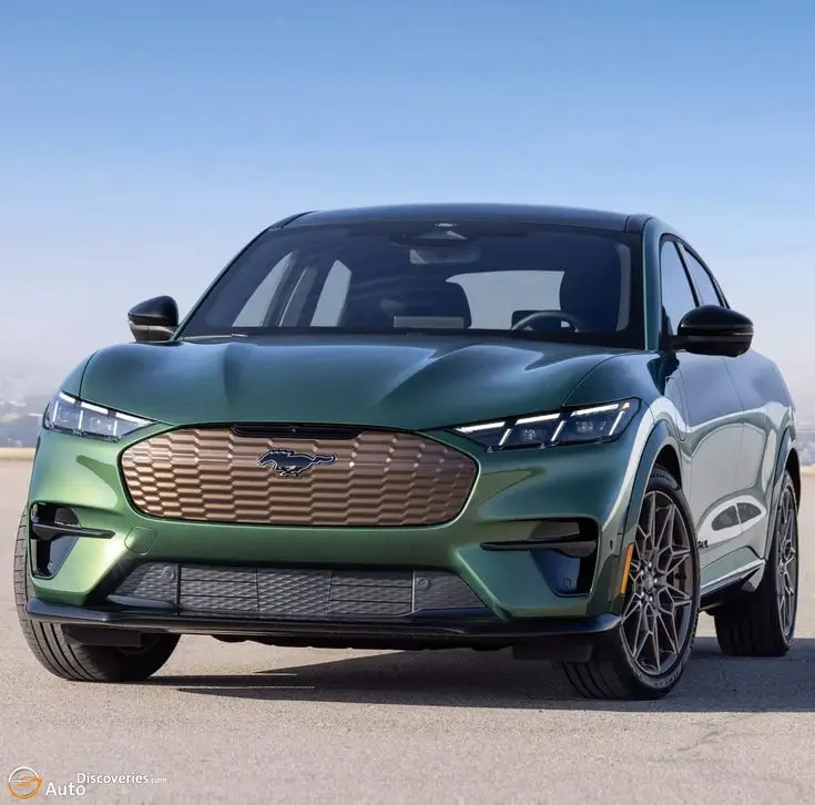 2024 Ford Mustang Mach-E GT Receives Bronze Appearance - Engine Stories Green Ford Mustang Mach-E electric SUV front view on a sunny day, showcasing sleek design and modern grille.