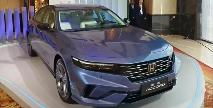 Sleek blue Honda Accord on display indoors, showcasing modern design and innovation.