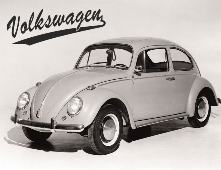 Vintage Volkswagen Beetle in a classic black and white photo with VW logo, showcasing iconic car design.