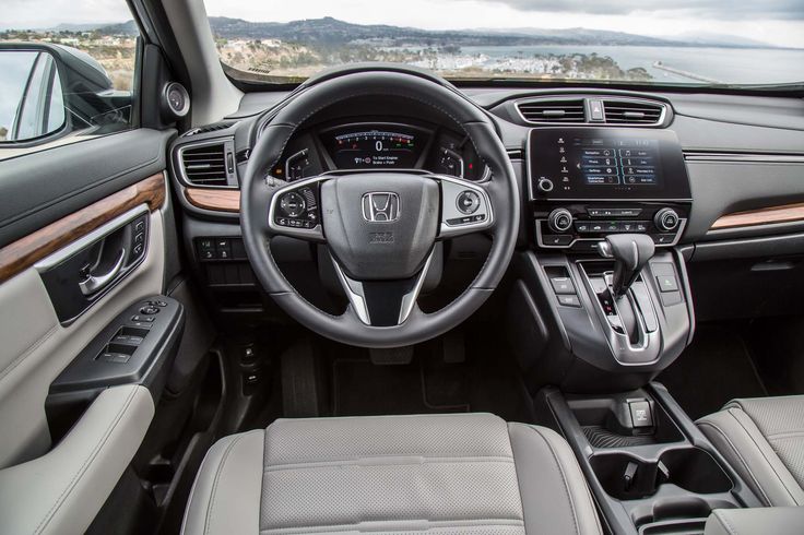 Interior of modern car showcasing sleek dashboard design, advanced infotainment system, and comfortable leather seating.