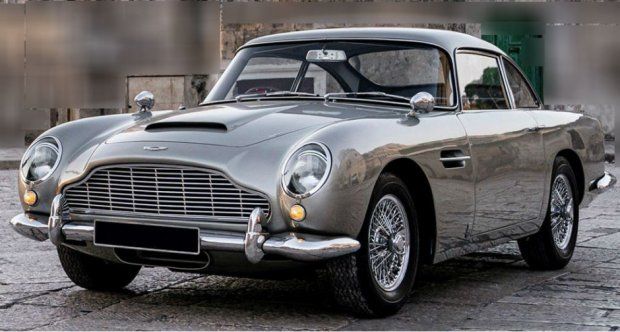 Classic silver luxury car parked outdoors, showcasing vintage design and sleek wheels for automotive enthusiasts.