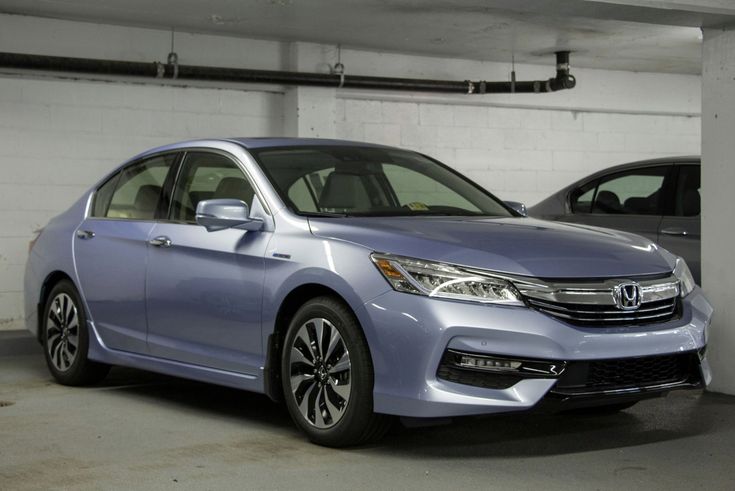 Sleek silver Honda Accord parked in a dimly lit garage, showcasing modern design and polished exterior.