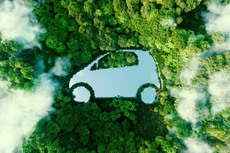 Aerial view of a car shape cut out of a forest canopy, symbolizing eco-friendly transportation and sustainability amidst nature.