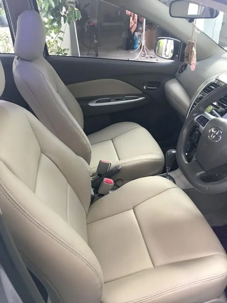 Inside cabin - Engine Stories Car interior with beige leather seats, steering wheel, and modern dashboard. Clean and spacious design.
