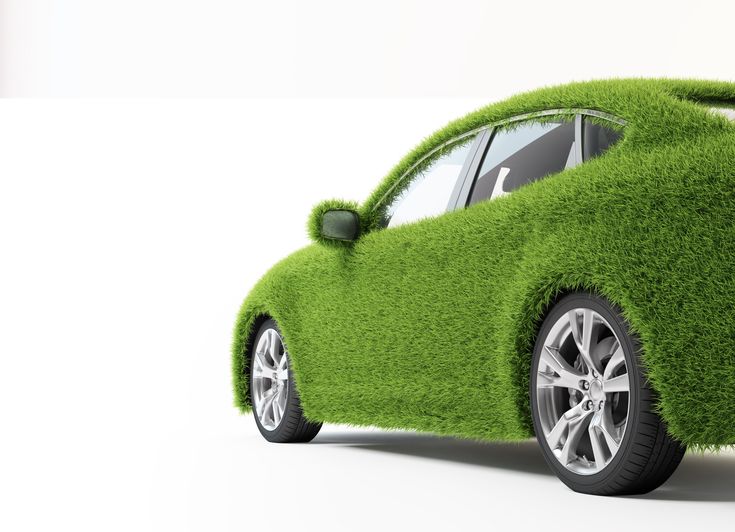 Eco-friendly concept car covered in green grass, symbolizing sustainable and green automotive technology.