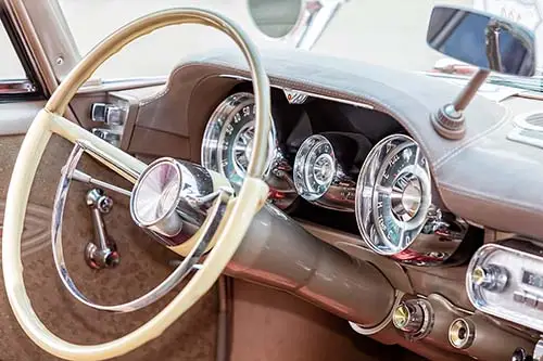 Munich, Germany, 23 July 2016: American muscle car, old car inte - Engine Stories Vintage car dashboard with chrome dials and ivory steering wheel, showcasing classic automotive interior design.
