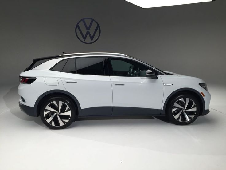 Electric SUV displayed in studio with Volkswagen logo, showcasing sleek design and modern features. Ideal for eco-friendly driving.