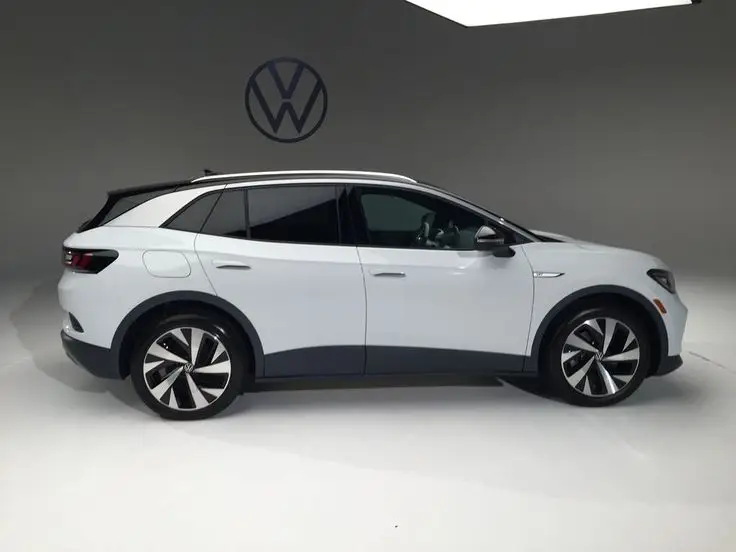 Volkswagen ID_4 Gallery of Photos - Engine Stories Electric SUV displayed in studio with Volkswagen logo, showcasing sleek design and modern features. Ideal for eco-friendly driving.