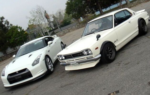 Two sleek white sports cars parked side by side, showcasing a classic and modern design comparison.