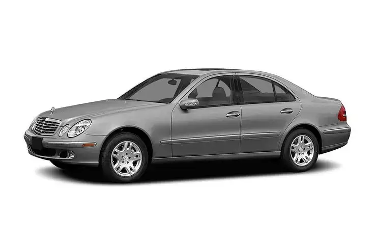 2004 Mercedes-Benz E-Class - Specs Prices MPG Reviews Photos _ Cars_com - Engine Stories Silver luxury sedan with chrome wheels, side view on a white background.