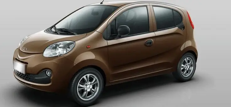Chery QQ 2015 - Engine Stories Brown compact car with modern design, viewed from side angle, featuring sleek lines and alloy wheels.