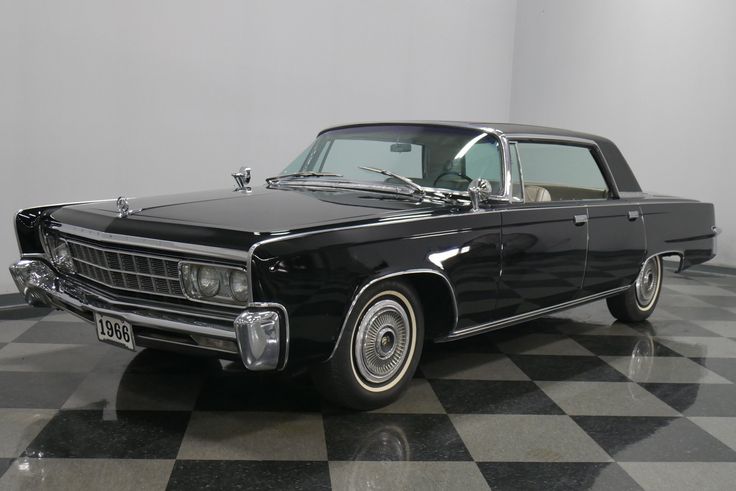 Chryslers Imperial 1966 - Engine Stories Classic 1966 black luxury car with chrome accents on display, checkered floor reflecting its sleek design.