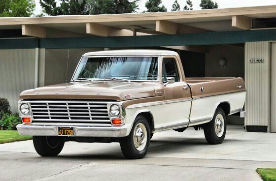 Ford F-150 truck - Engine Stories Classic vintage brown and white pickup truck parked in a driveway, showcasing retro design and style.