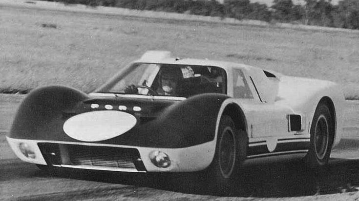 Ford GT J-Car - Engine Stories Vintage race car speeding on a track, showcasing sleek design and dynamic motion, capturing classic motorsport elegance.