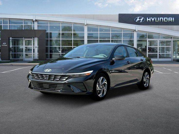 Black Hyundai car parked in front of a dealership, showcasing sleek design and modern features.