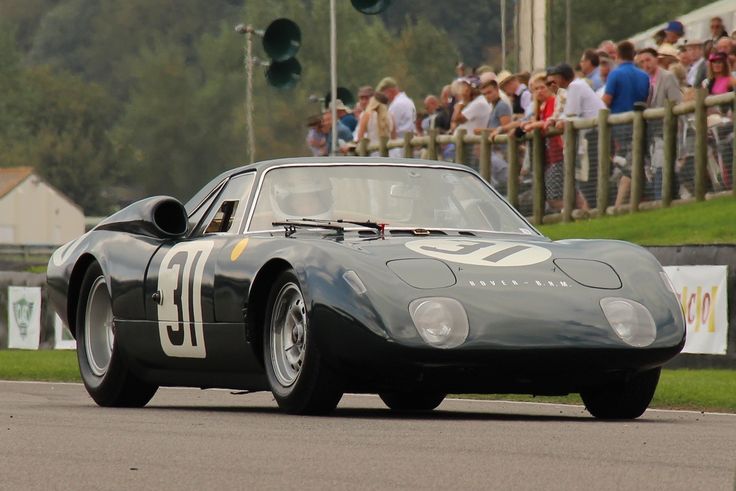 Inside British Motorsport - 1965 Rover BRM gas turbine 2 _ ClassicCars_com Journal - Engine Stories Vintage race car with the number 31 on track, spectators in the background, showcasing classic motorsport excitement.