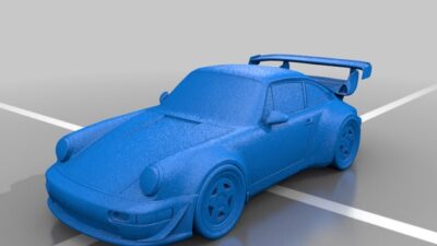 Blue sports car model with aerodynamic design and rear spoiler on a gray background.