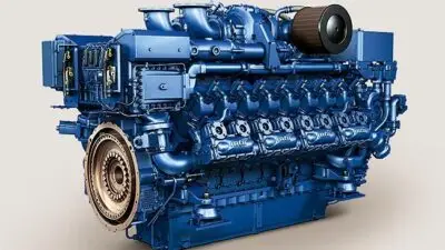 Blue industrial diesel engine with complex components and intricate details, showcasing engineering and mechanical design.