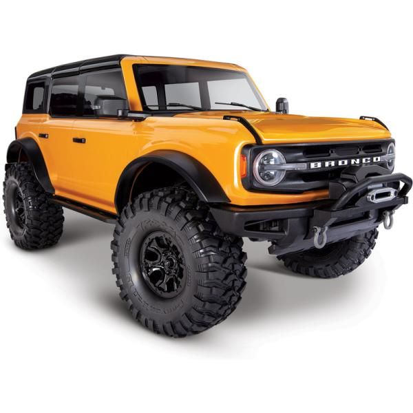 Traxxas TRX-4 Ford Bronco 2021 1_10 RTR narancssárga - Engine Stories Yellow off-road vehicle with lifted suspension, rugged tires, and Bronco grille badge. Ideal for adventurers and outdoor enthusiasts.