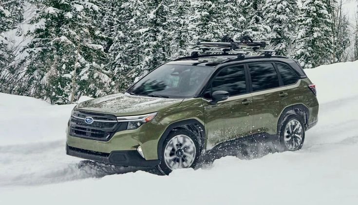 Olive green SUV driving through snowy forest terrain, showcasing winter off-road capabilities and rugged design.