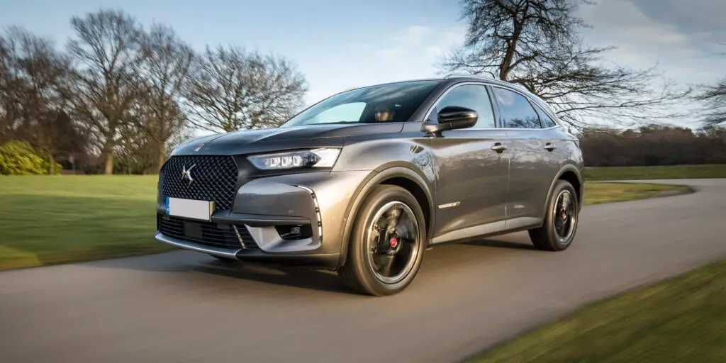 ds-7-crossback-review-9 - Engine Stories Sleek grey SUV driving on a scenic road, blending elegance with performance. Perfect for modern adventures.