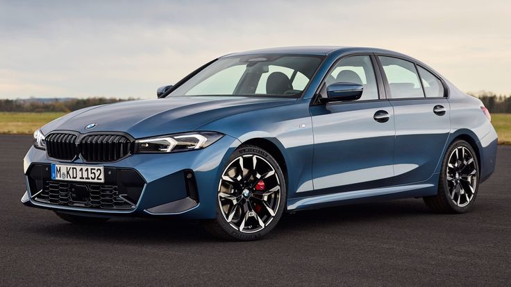 Blue BMW sedan on open road, showcasing sleek design and modern features. Perfect for luxury car enthusiasts and BMW fans.