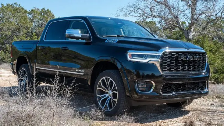 ed2ec3a25d5b7093f8dedd25ecb5ede3 - Engine Stories Black Ram 1500 truck parked outdoors, showcasing its sleek design and rugged features with trees in the background.