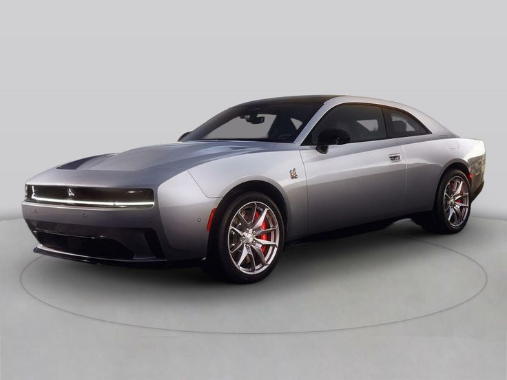 Silver modern muscle car with sleek design on a neutral backdrop.