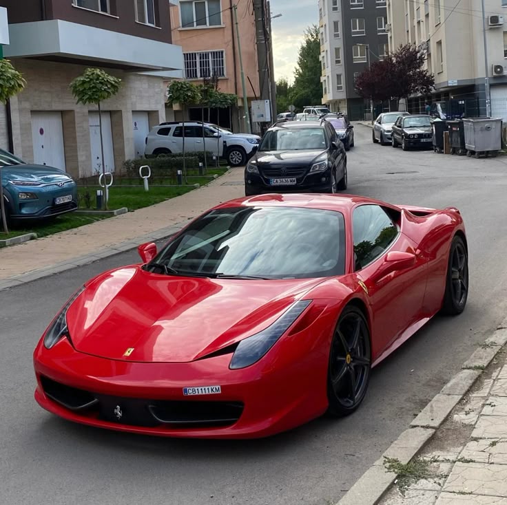 Red luxury sports car parked on a residential street, showcasing sleek design and elegance amid urban surroundings.