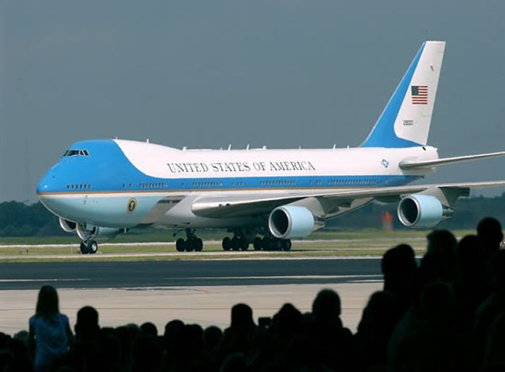 Air Force One Boeing 747-200B Aircraft - Engine Stories Air Force One preparing for takeoff on a runway, crowd watching. Iconic presidential aircraft of the United States on display.