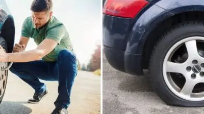 Man changing a flat tire on the roadside; close-up of the flat car tire on asphalt.