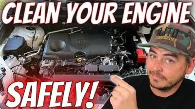 Man pointing at a car engine with text: Clean Your Engine Safely! Tips for safe engine cleaning demonstrated.