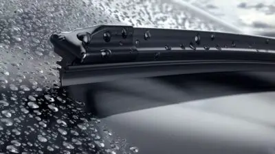 Close-up of a car windshield wiper blade clearing raindrops, showcasing efficient water removal and sleek design.