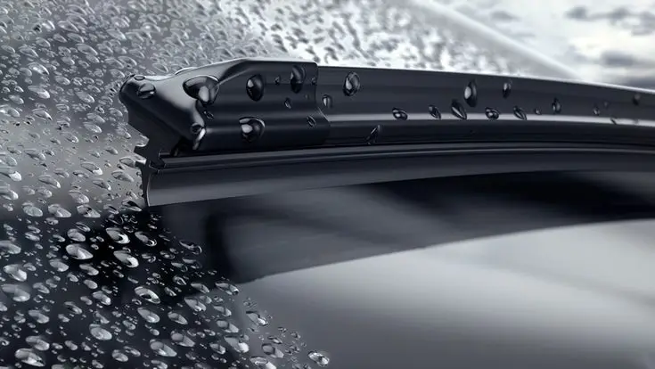 Close-up of a car windshield wiper blade clearing raindrops, showcasing efficient water removal and sleek design.