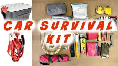 Car survival kit essentials including jumper cables, tools, gloves, and emergency gear for roadside safety.