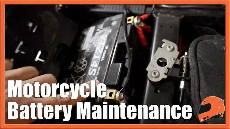 Close-up of a motorcycle battery with text Motorcycle Battery Maintenance overlaying the image.