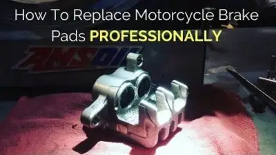 Guide on replacing motorcycle brake pads professionally with tools on a workbench for effective maintenance and repair.