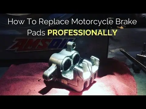 Guide on replacing motorcycle brake pads professionally with tools on a workbench for effective maintenance and repair.