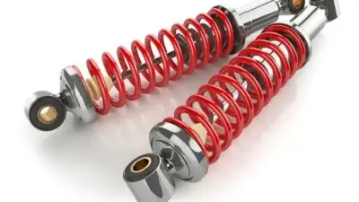 Two chrome and red coil shocks for motorcycles, showcasing high-performance suspension with stylish design. Perfect for bike customization.