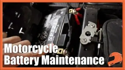 Guide on Motorcycle Battery Maintenance: Close-up of a battery being serviced, emphasizing essential upkeep tips for riders.
