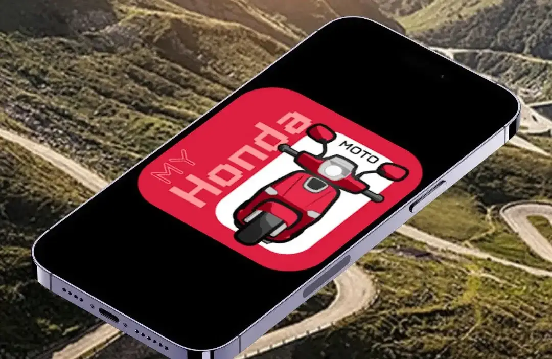 Smartphone displaying My Honda Moto app logo with red scooter, set against a scenic winding road backdrop.