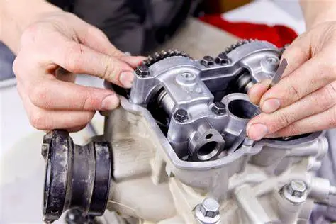 Mechanic adjusting camshaft components on an engine.