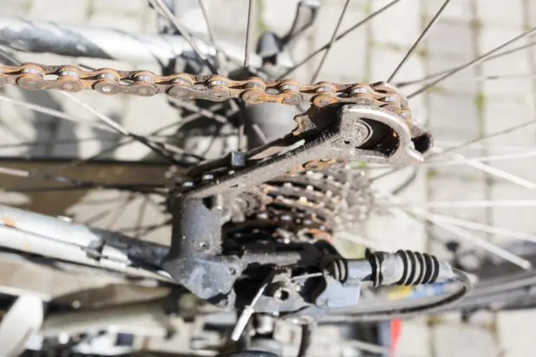 Close-up of a rusty bicycle gear and chain, highlighting mechanical wear and maintenance needs.