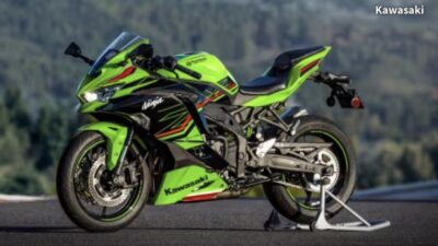 Green Kawasaki Ninja sportbike on a stand with scenic background, showcasing sleek design and performance features.
