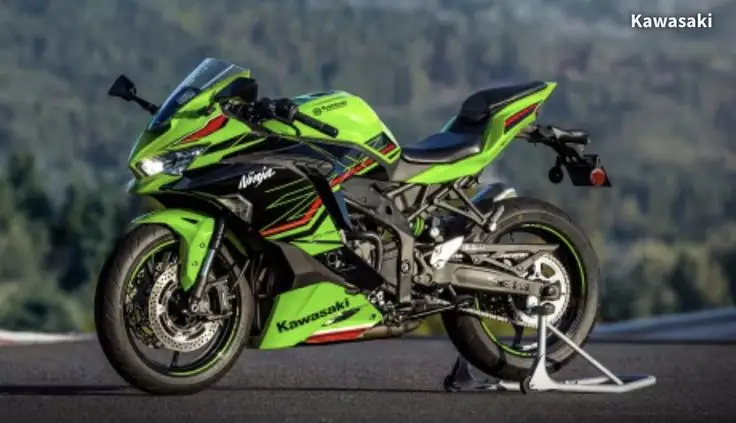 Green Kawasaki Ninja sportbike on a stand with scenic background, showcasing sleek design and performance features.