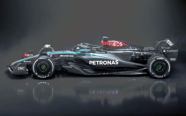 Sleek black and silver Formula 1 race car with prominent Petronas branding, showcasing aerodynamic design and sponsors.