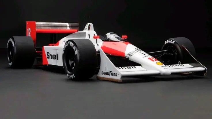 Classic Formula 1 race car with Goodyear tires, Shell branding, and striking red-white design, showcased against a dark backdrop.