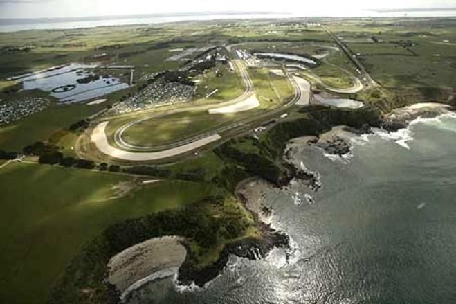 What a place to have a race track_ Legendary - Engine Stories Aerial view of a coastal racing circuit with lush greenery and ocean backdrop, showcasing the track's proximity to the coastline.